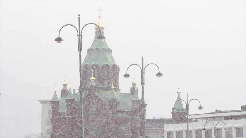 Snowing in winter Helsinki, Finland. View of Uspenski Cathedral  from market Square in february day