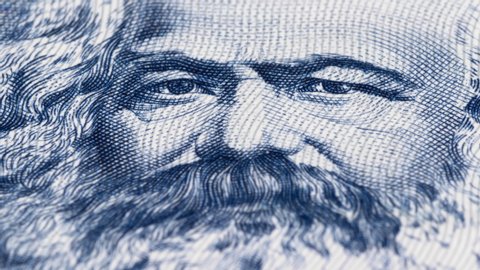 Karl Marx portrait on East German banknote tracking. Dolly shot. Low angle, macro. 4K