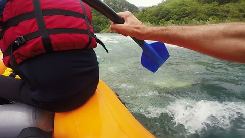 POV Shot of White Water Rafting on Rough Water. Whitewater Rafting Teams Descending Raging Rapids. People White Water Rafting on Mountain River. Mountain River Flowing Through A Canyon.