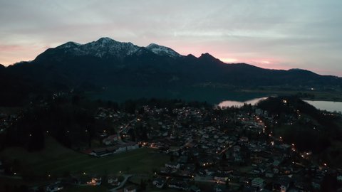 4K UHD night flight over Kochel am See with sunset and alps in the backround