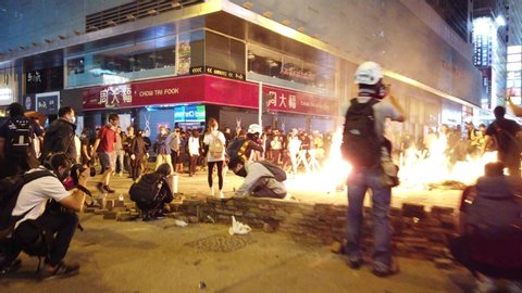 Hong Kong - November , 2019: Burning barricades and people protest at night during Hong Kong Protests