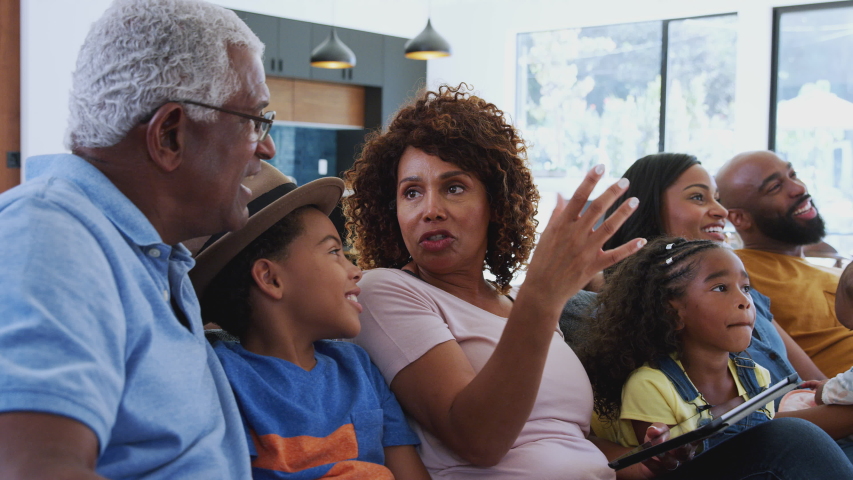 Multi-generation African American family relaxing at home sitting on sofa watching TV together - shot in slow motion | Shutterstock HD Video #1047139630