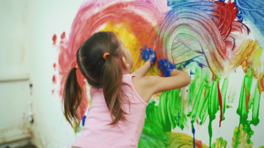 Little Girl Child Preschooler Draws Hands Paints On White Wall. Royalty-Free Stock Footage #1047157561