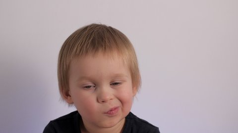 Close up tired little cute baby feeling boring portrait of yawn European boy having tiredness facial expression face of fatigue kid relaxing wanted sleeping posing isolated at white studio background