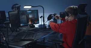 Medium shot of a boy playing a VR shooter video game in an office