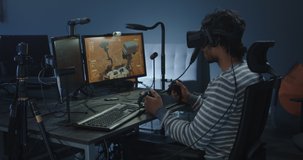 Medium shot of a developer playing a VR game or simulator controlling a Mars rover