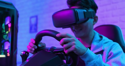 asian gamer play car racing game with wearing vr glasses