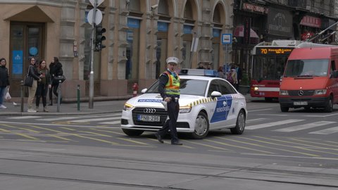 Budapest / Hungary - 07 11 2019: Police Man Almost Gets Hit By Police Car In Budapest, Hungary
