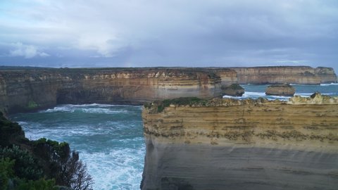 Amazing view along Great Ocean Road, big waves crushing on the rocky cliff coast in 12 Apostles Victoria Australia
