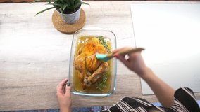 woman greases a chicken with sunflower oil
