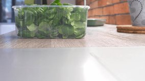 spinach in plastic box on a table