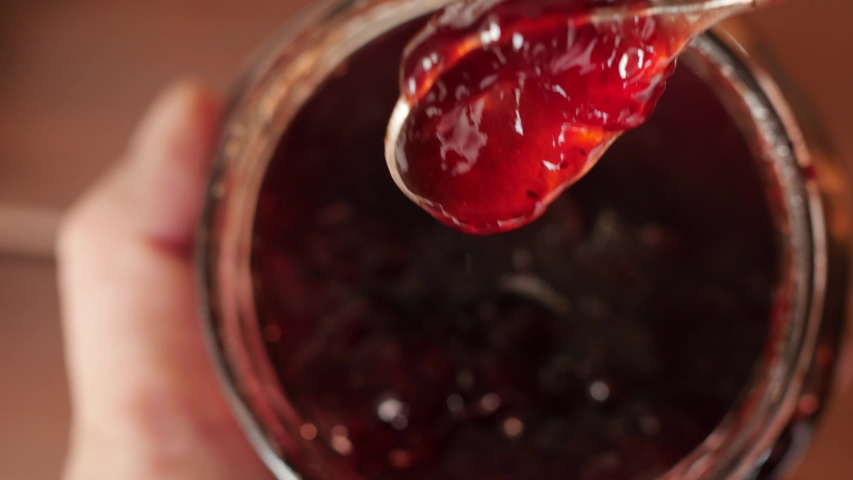 Red strawberry jam, raspberry in a jar | Shutterstock HD Video #1047193549