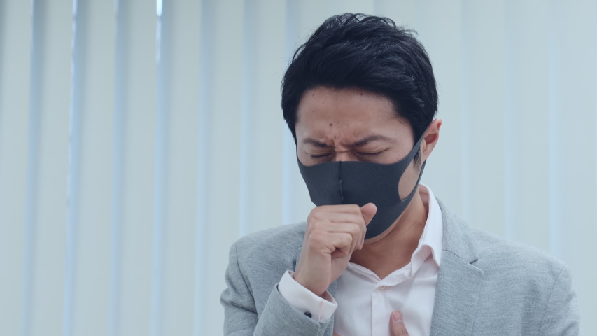 Coughing asian businessman. Surgical mask. Royalty-Free Stock Footage #1047194182