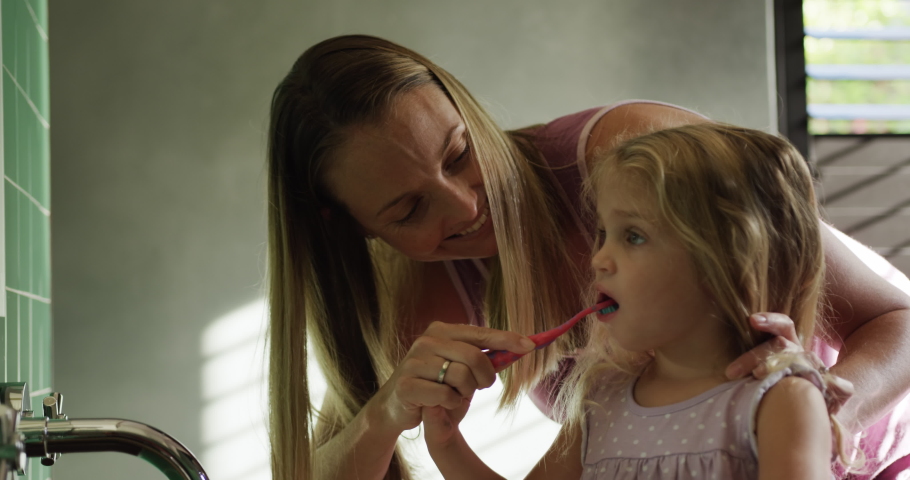 Front view close up of a Caucasian woman enjoying free time at home in the bathroom with her daughter Social distancing and self isolation in quarantine lockdown for Coronavirus Covid19