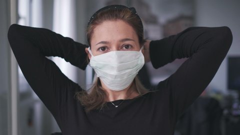 woman putting on surgical mask for corona virus prevention. 