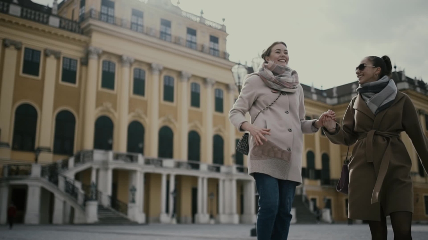 Two young girls tourists walk and enjoy together in Vienna (Europe, Austria).