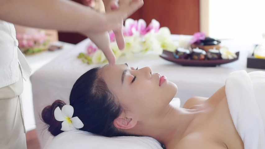 Massage concept. Beautiful Asia young woman reciving relxing massage