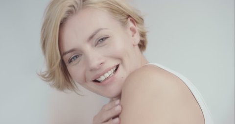 Close up portrait of beautiful woman smiling in luxury home enjoying relaxed lifestyle in front of soft out of focus background slow motion 6K RED EPIC DRAGON