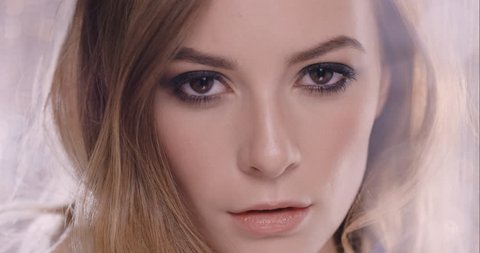 Close up of sexy woman touching face posing for beauty portrait on sparkle shimmer curtain background glamorous fashion model moving in slow motion seductive concept shot in 6K on RED EPIC DRAGON