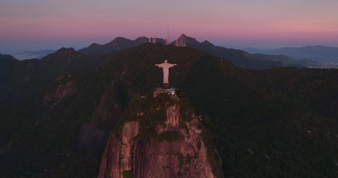 RIO DE JANEIRO, BRAZIL - FEBRUARY 2020: Aerial helicopter panorama of Rio de Janeiro with Christ the Redeemer Statue on the top of Corcovado Hill. Wide angle view with warm sunrise colors.