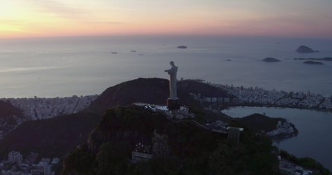 RIO DE JANEIRO, BRAZIL - FEBRUARY 2020: Aerial helicopter view of Rio de Janeiro with Christ the Redeemer Statue on the top of Corcovado Hill. Wide angle view with sunrise light