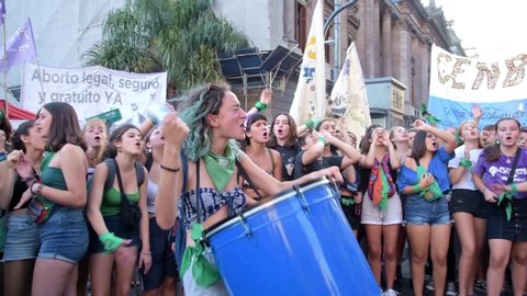 Capital Federal, Buenos Aires / Argentina. Feb 19, 2020: young girl shouting slogans and playing a drum in a demonstration in favor of the approval of the law of legal, safe and free abortion