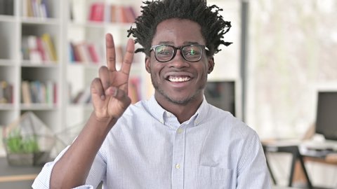 Victory Sign by Successful Young African Man 