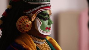 Close up of a Kathakali dancer smiling.