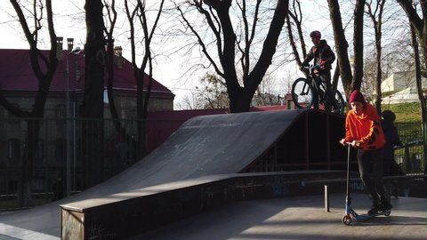 LVIV, UKRAINE - FEBRUARY 22, 2020: City public Skatepark, a platform for cycling. Slow motion.