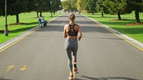 Back view disabled runner training in green park. Sportsperson exercising on asphalt surface in slow motion. Energetic woman running on road - Powered by Shutterstock - Get 15% off with code: PIKWIZARD15