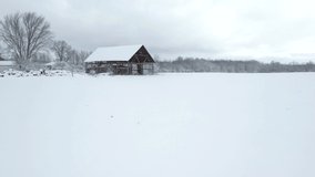Winter flyby of scenic old barn without walls.
