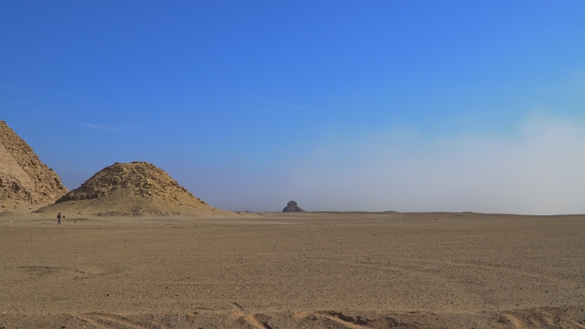 The Bent Pyramid is an ancient Egyptian pyramid located at the royal necropolis of Dahshur, approximately 40 kilometres south of Cairo, built under the Old Kingdom Pharaoh Sneferu. Egypt
