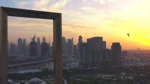 Dubai, UAE - February 2020: Amazing aerial view of panoramic Dubai skyline and Burj Khalifa with golden frame during sunset in Dubai, UAE