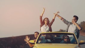 The young people traveling by yellow cabriolet and dancing. slow motion - Powered by Shutterstock - Get 15% off with code: PIKWIZARD15