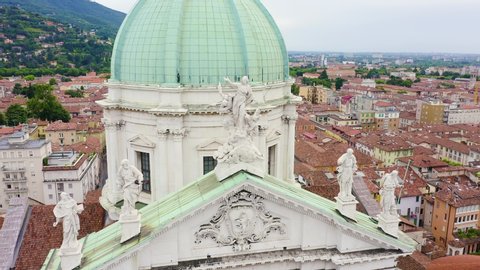 Brescia, Italy. Cathedral of Santa Maria Assunta. Flight over the city in cloudy weather, Aerial View, Departure of the camera