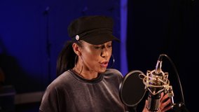 4K: Female Singer / Popstar recording an Album in the studio - She sings into the Microphone with a pop filter - Stock Video Clip Footage