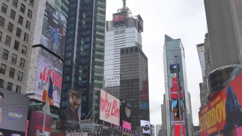 NEW YORK CITY - SEPTEMBER 2016: Tilt-down shot of digital screens and billboards at crowded Times Square in New York City, USA
