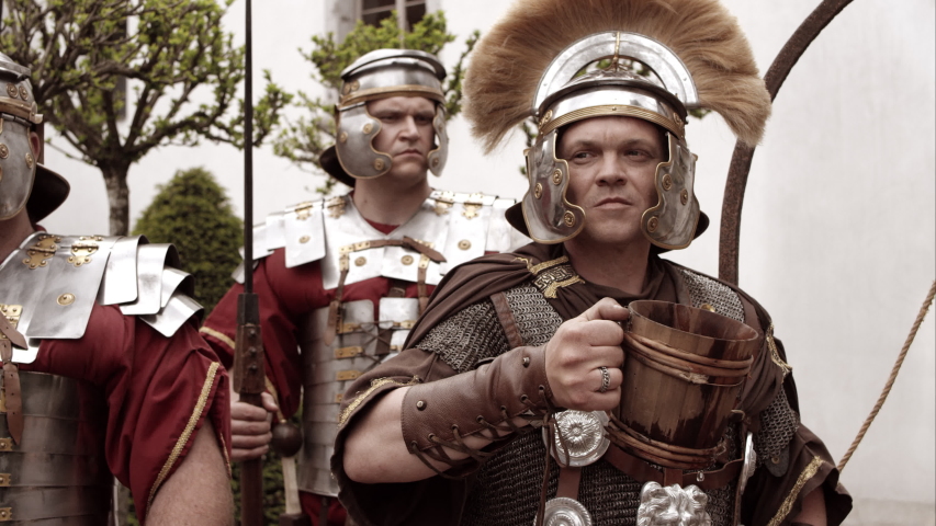 Centurion And Two Soldiers Shout Triumphantly While Centurion Holds Drink