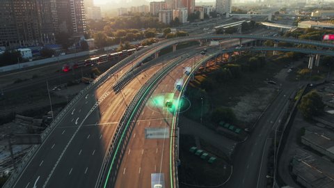 Amazing aerial presentation of the autonomous cars self-driving concept on the sunny evening in Moscow. Beautiful view from above to the road traffic on multi-level highway of big city.