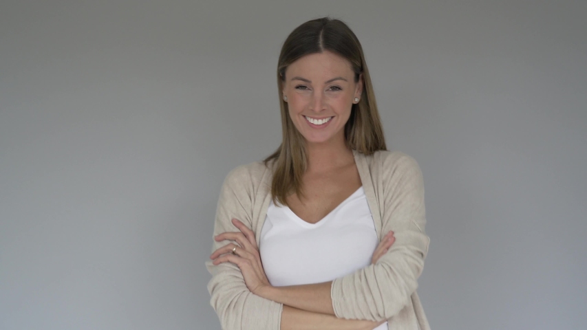 Portrait of cheerful woman showing thumbs up on grey background, isolated