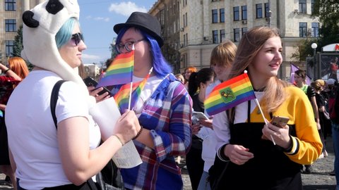 KHARKIV, UKRAINE - September 15, 2019: People hold huge rainbow stuff at Gay Pride parade. Claiming for equality and legal rights for LGBTQI+ community. Rainbow flag at gay or lesbian pride parade
