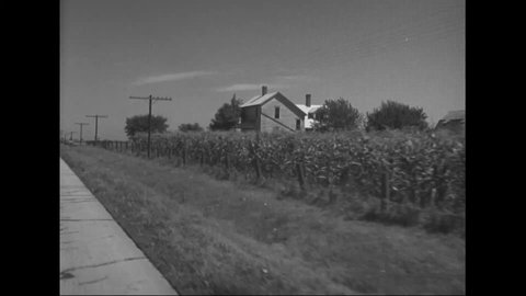CIRCA 1930s - Footage is shot from a car as it drives past farmland in New York.