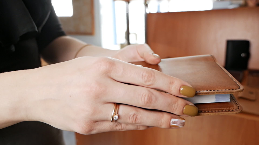 Leather diary, notebook demonstration in the hands of a woman. Leather workshop