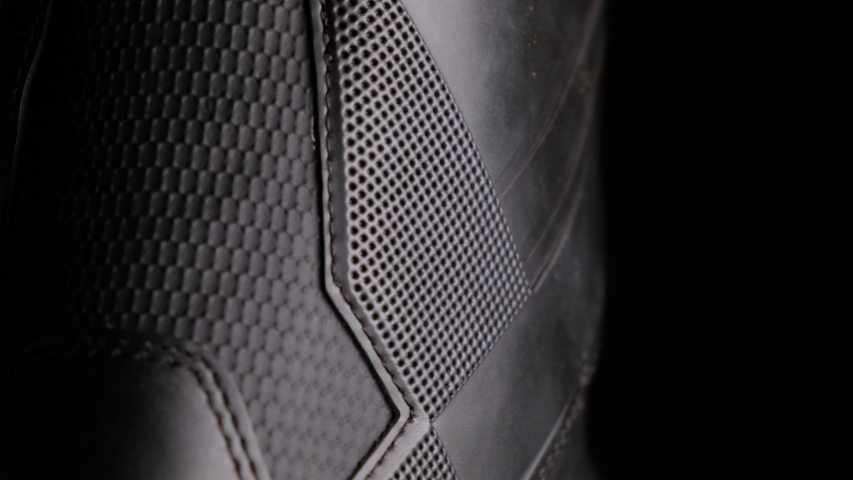 A close up shot of snowboard boots against black background, abstract pattern, black & white design, with black empty negative space, room for text and title, vivid light fall off and highly detailed