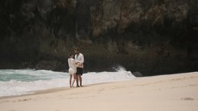 Young handsome man doing proposal to his beautiful girlfriend on empty tropical beach. Romantic couple getting engaged on paradise island. Touching moment