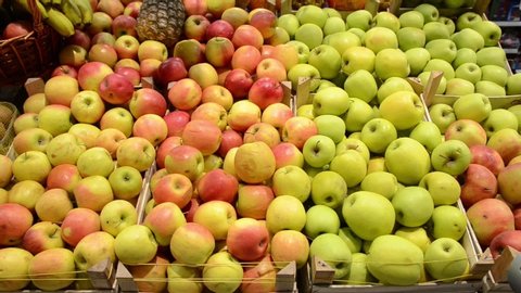 Organic and fresh apples on fruit market, close up. Boxes full of ripe apples for sale on farmers market. Fresh fruit display in shop. Juicy apple at the greengrocer's stall. Agriculture. Food product