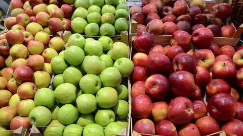 Organic and fresh apples on fruit market, close up. Boxes full of ripe apples for sale on farmers market. Fresh fruit display in shop. Juicy apple at the greengrocer's stall. Agriculture. Food product