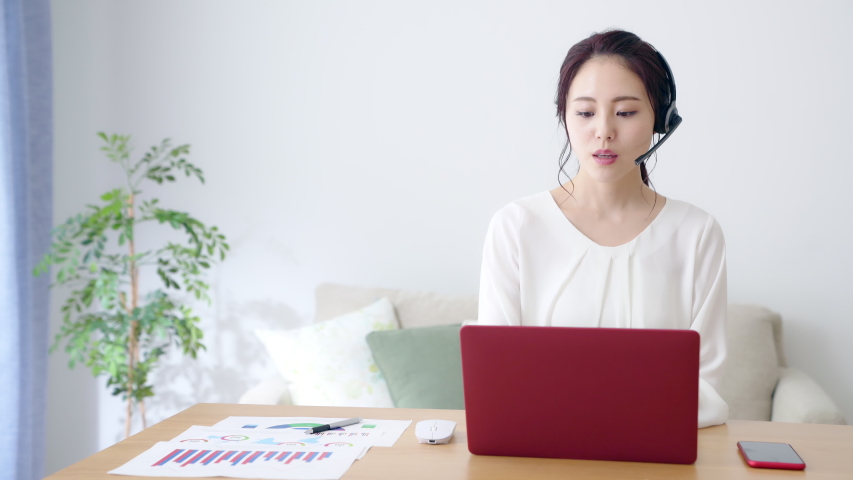 Working asian woman in the living room. Telemeeting. Video conference. Remote work. Royalty-Free Stock Footage #1047398578