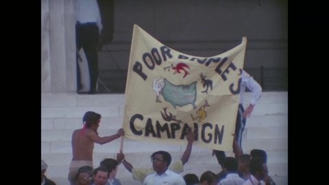 CIRCA 1968 - Members of the Poor People's Campaign gather at the Lincoln Memorial, holding up banners.