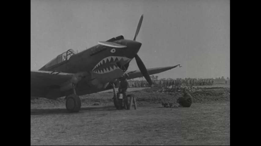 CIRCA 1940s - Chinese men and women help construct an airfield for the Flying Tigers, which planes then taxi on and takeoff from. | Shutterstock HD Video #1047398941